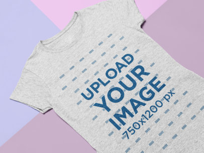 Mockup of a Heathered Tee Laid Flat on Three Pasteboards