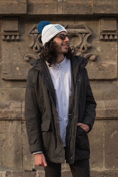 Mockup of a Man Wearing a Beanie in Front Of a Quarry Wall