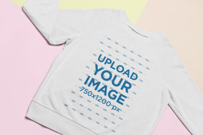 Flat Lay Mockup of a Sweatshirt Over Colored Pasteboards