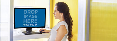 Desktop PC Mockup of a Pretty Lady at a Creative Office