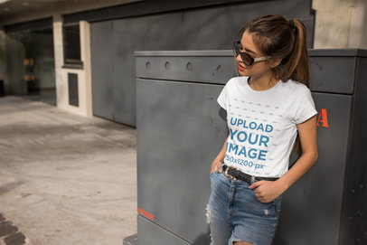Tee Mockup of a Woman Wearing Sunglasses in the Street