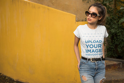 Mockup of a Woman Wearing a T-Shirt in Front of a Yellow Wall