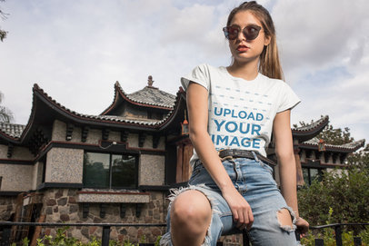 Mockup of a Cool Woman Wearing a Tee in Front of an Oriental House