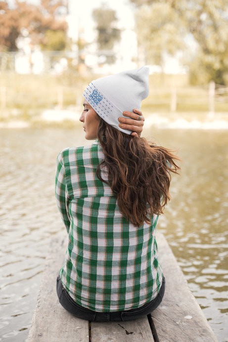 Beanie Mockup of a Woman Sitting by a Lake
