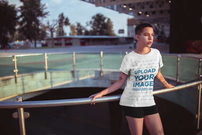Mockup of a Woman with Tattoos Wearing a T-Shirt Outside