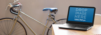 Mockup of a Laptop Sitting on Top of a Table at a Creative Office