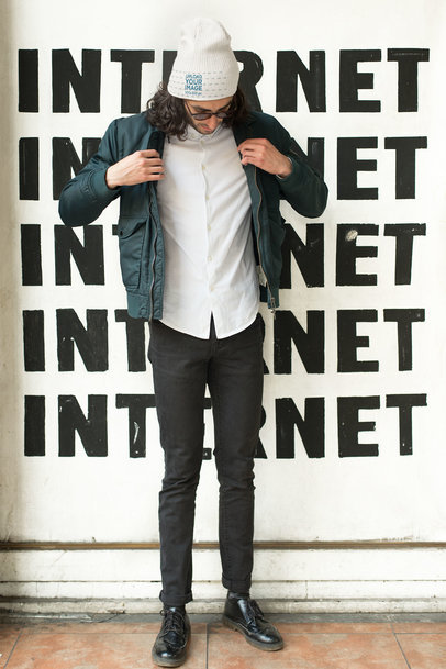Beanie Mockup of a Cool Man Standing Against a Wall with Letters 