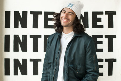 Mockup of a Man Wearing a Knit Beanie and Winking