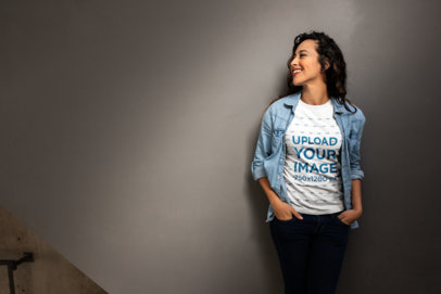 Mockup of a Woman Casually Leaning on a Wall Wearing a T-Shirt