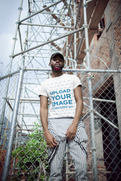 T-Shirt Mockup of a Man Wearing Trendy Striped Overalls