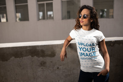 Urban Mockup of a Woman Wearing a T-Shirt and Sunglasses