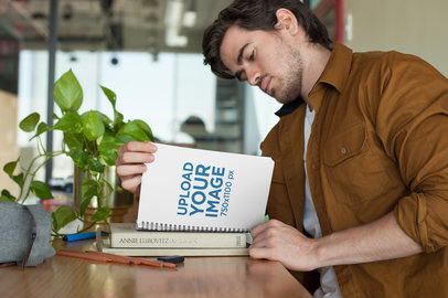 Notebook Mockup Featuring a Young Man Studying