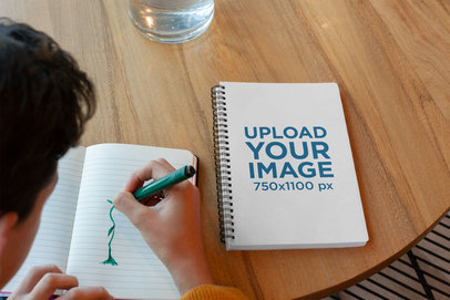 School's Notebook Mockup Featuring a Boy Drawing