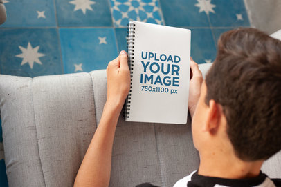 Mockup of a Boy Looking at His School's Notebook