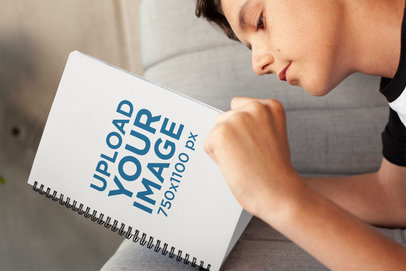 Mockup of a Boy Reading His Notebook