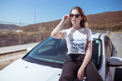 T-Shirt Mockup of a Cool and Trendy Woman Sitting on a Car