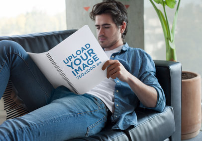 Notebook Mockup of a Relaxed Man Lying on His Couch 24171