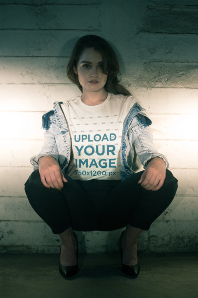 Tshirt Mockup of a Handsome Female Model Crouching at Night