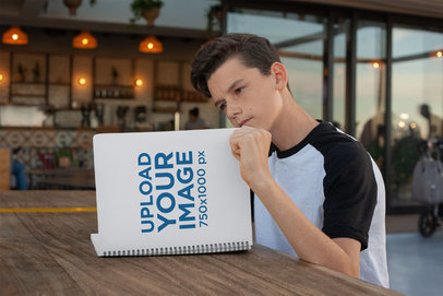 School Notebook Mockup of a Young Boy Reading Attentively