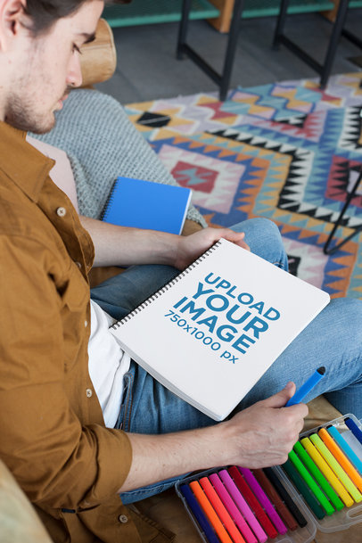 School Notebook Mockup with a Young Man Looking at His Notebook