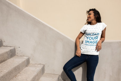 T-Shirt Mockup Featuring a Happy Woman in an Urban Environment