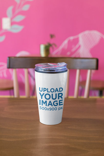 Travel Mug Mockup Featuring a Desk in a Modern Office