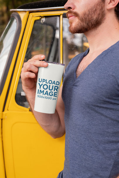 Mockup of a Man Holding a Travel Mug by a Yellow Car 24396