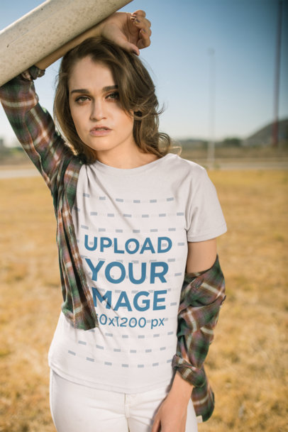 Mockup of a Fashionable Woman Wearing a T-Shirt in a Field