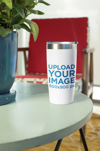 Mockup of a Travel Mug Standing on an End Table