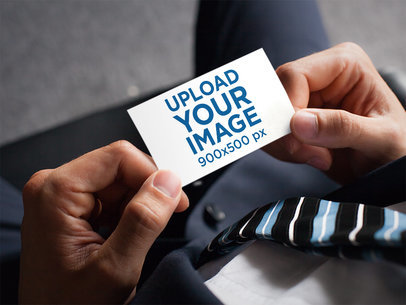 Business Card Mockup Featuring a Businessman Holding a Business Card 
