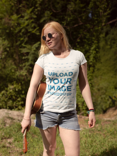 Camping T-Shirt Mockup Featuring a Beautiful Woman Carrying the Ukulele