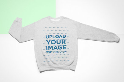 Flat Lay Mockup of a Crewneck Sweatshirt over a Colored Background