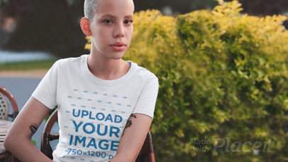 Parallax Video Mockup of a Woman with a Buzz Cut Wearing a Tee