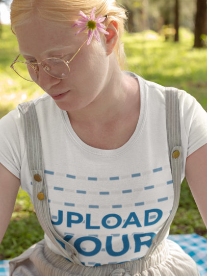 Mockup of a Beautiful Woman with Glasses Wearing a T-Shirt in a Meadow
