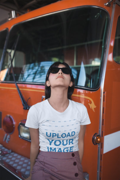 Mockup of a Woman Wearing a T-Shirt while by a Fire Engine