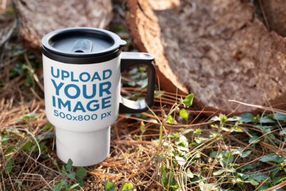 Mockup of a Travel Mug Standing in a Wooden Area