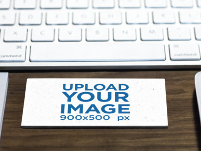 Mockup of a Business Card in Landscape Position on Top of a Desk