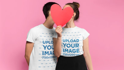 Valentine's Day T-Shirt Mockup of a Couple Hiding Behind a Paper Heart