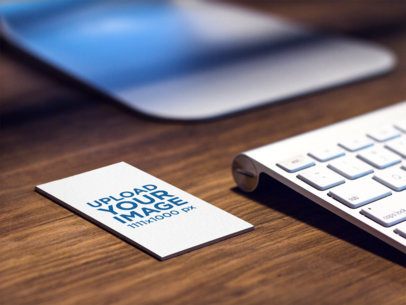 Mockup of a Business Card Lying on Top of a Desk at a Creative Office