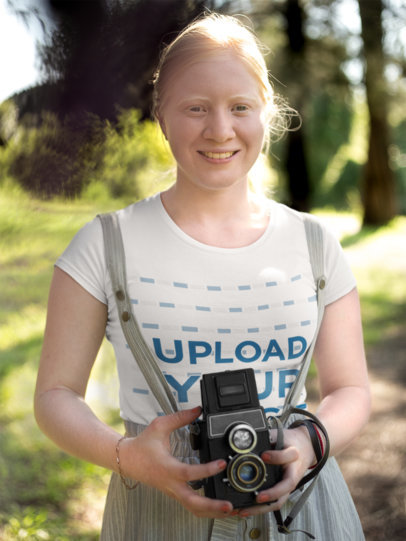 Mockup of a Woman Holding a Vintage Camera