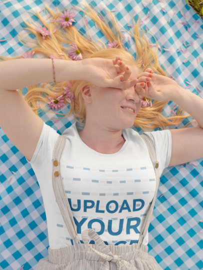 T-Shirt Mockup of a Beautiful Woman Lying on a Picnic Blanket
