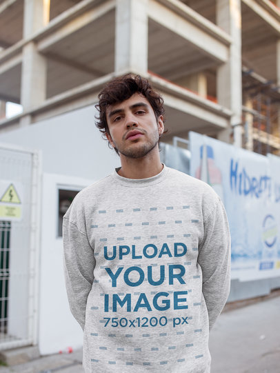Heather Sweatshirt Mockup of a Serious Man Outside a Building Under Construction