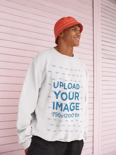 Crewneck Sweatshirt Mockup of a Happy Man Standing Against a Pink Metal Wall