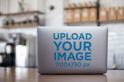 Laptop Sticker Mockup Featuring a Laptop in a Café