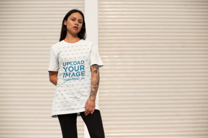 Mockup of a Serious Woman Wearing a Unisex T-Shirt Outside