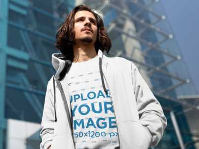 Mockup of a Serious Man Wearing a Sweatshirt Outside a Modern Building