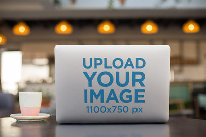 Laptop Sticker Mockup Featuring a Cafe