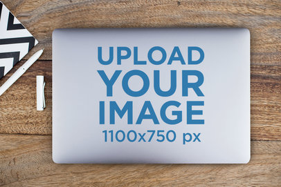 Flat Lay Mockup of a Laptop Sticker on a Desk