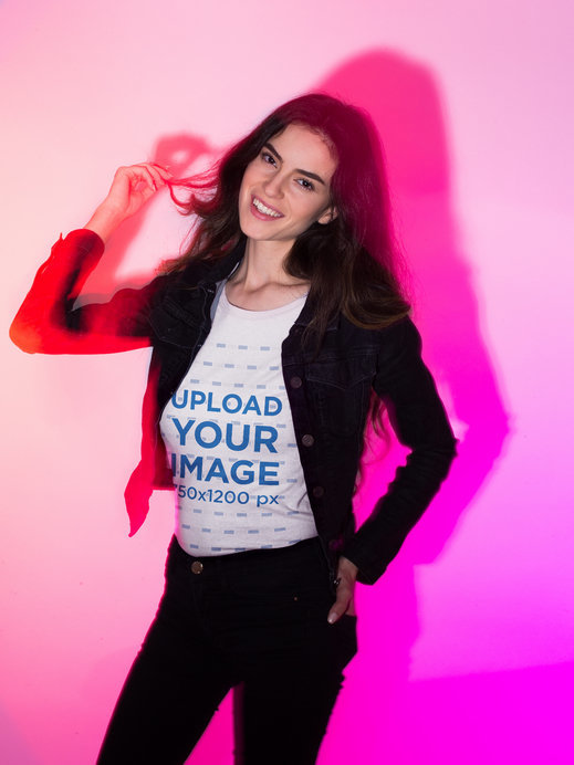 T-Shirt Mockup of a Woman in a Pink Light Studio