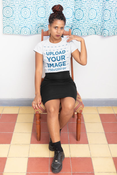 T-Shirt Mockup of a Woman with Locs Sitting on a Vintage Chair 